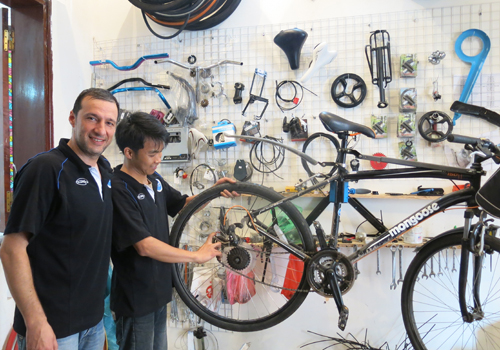 Foreign man repairs bicycles in Hanoi